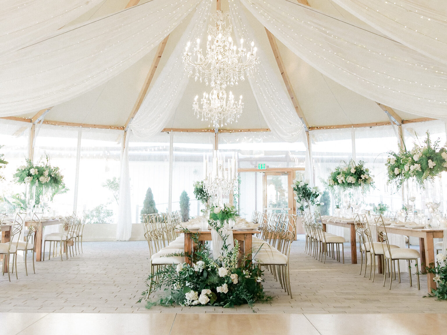 tented ballroom with florals, chandeliers and lights at the bohlin in newport